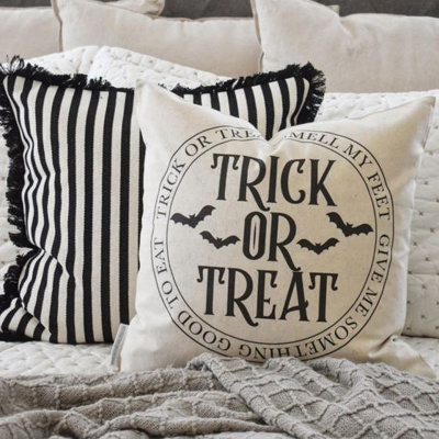 Trick or Treat Halloween pillow on a bed
