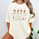 Medium Ivory Wildflower Skeleton Graphic Tee, Boho Halloween Shirt, Cute Halloween Tee, Dancing Skeleton Shirt, Comfort Colors