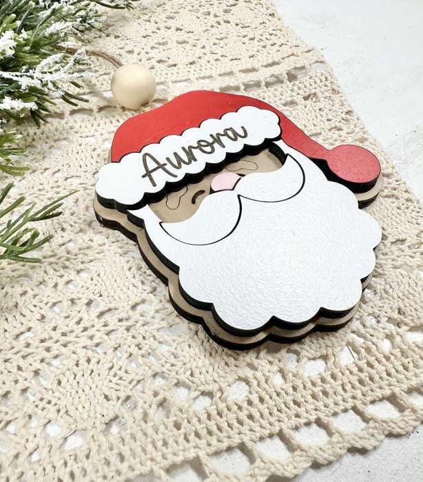 Personalized Santa Claus Ornament  Size: 4''X4.5''  This ornament is laser cut with two layer giving the ornament a 3D look, the name is engraved  It arrives ready to hang with twine string and one wo