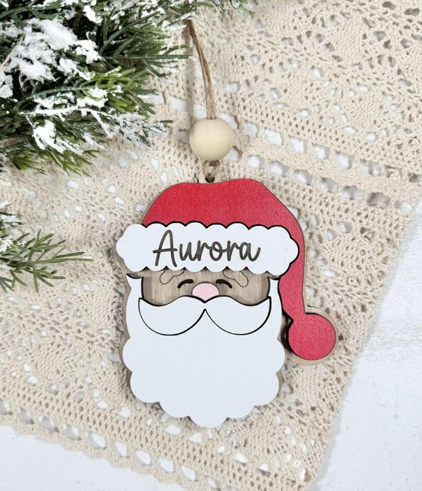 Personalized Santa Claus Ornament  Size: 4''X4.5''  This ornament is laser cut with two layer giving the ornament a 3D look, the name is engraved  It arrives ready to hang with twine string and one wo