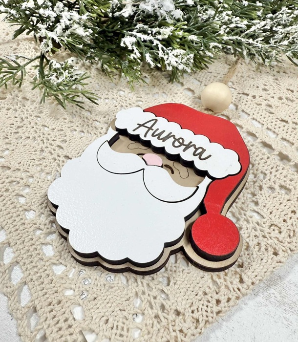 Personalized Santa Claus Ornament  Size: 4''X4.5''  This ornament is laser cut with two layer giving the ornament a 3D look, the name is engraved  It arrives ready to hang with twine string and one wo