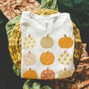  Faux (Printed, not real glitter or fabric)     Glitter Pumpkins In A Grid For Fall - T-Shirt (Crewneck)  100 Cotton Solid Colors Jersey Tee (Unisex)  Bella Canvas