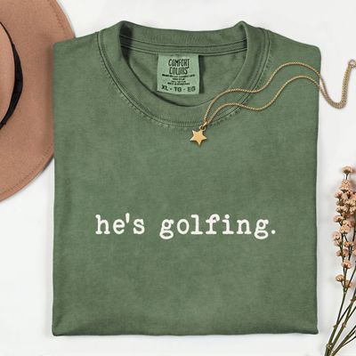 Hes Golfing - Funny Sarcastic Sayings - T-Shirt (Crewneck)  Soft Wash Cotton Heavyweight Tee (Unisex) Comfort Colors