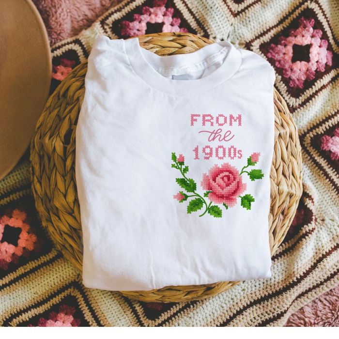 From The 1990s Cross Stiched Rose Vintage Faux (Printed, not real fabric or embroidery)  Embroidery - Soft Longer Length Bella Canvas Tee