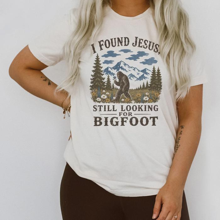 I Found Jesus, Still Looking For Bigfoot - Funny Christian Outdoorsy - T-Shirt Options (Main Image - Comfort Colors - Ivory)
