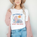 DO MORE OF WHAT YOU LOVE | Unleash the Joy: A Dinosaur's Delight Soft Cozy Longer Length Unisex Graphic Tee T-shirt