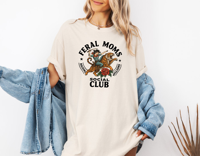 FERAL MOMS | RAISING HELLIONS | SOCIAL CLUB | Wild Women Unite: A Celebration of Fierce Femininity Unisex Heavyweight Comfort Tee