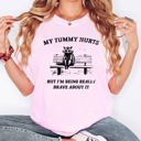 Medium Blossom Light Pink My Tummy Hurts Raccoon Meme Deluxe Edition Collectible Meme Premium Collection Comfort Colors Tee
