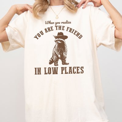 When You Realize, You Are The Friend In Low Places Raccoon Sarcastic Graphic Tee