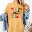 Medium Mustard Merry And Bright Colorful Christmas Winter Santa Claus North Pole Holiday Cheer For Everyone Comfort Colors Tee