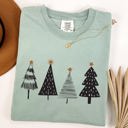 Small Bay Light Sage Minimalist Christmas Trees Winter Snow Santa Holiday Scene Nordic Winter Nights Cozy Atmosphere Comfort Colors Tee