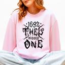 Large Light Pink 1692 They Missed One Salem Spooky Witch Halloween Night Edition Deluxe Cozy Graphic Sweatshirt