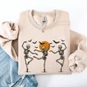 XL Sand Skeleton Dancers Halloween Parade Vintage Moonlit Street Scene Cozy Retro Sweatshirt