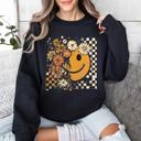 Large Black Retro Smiley Halloween Floral Autumn Garden Flowers Vintage-Inspired Pattern Cozy Knit Sweatshirt