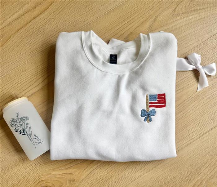 Embroidered Mini Flag & Bow 4th of July Sweatshirt – Cute Patriotic Crewneck for Women, USA Flag Embroidery, Independence Day Outfit